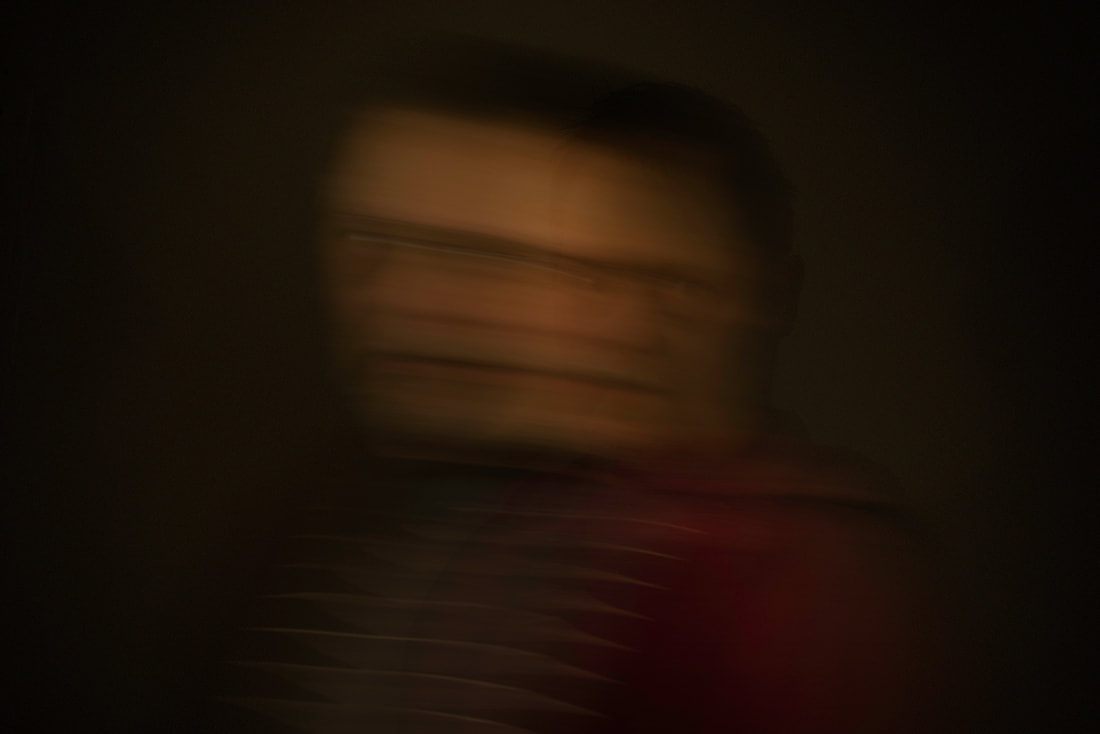 Blurry portrait of a person in a dark room