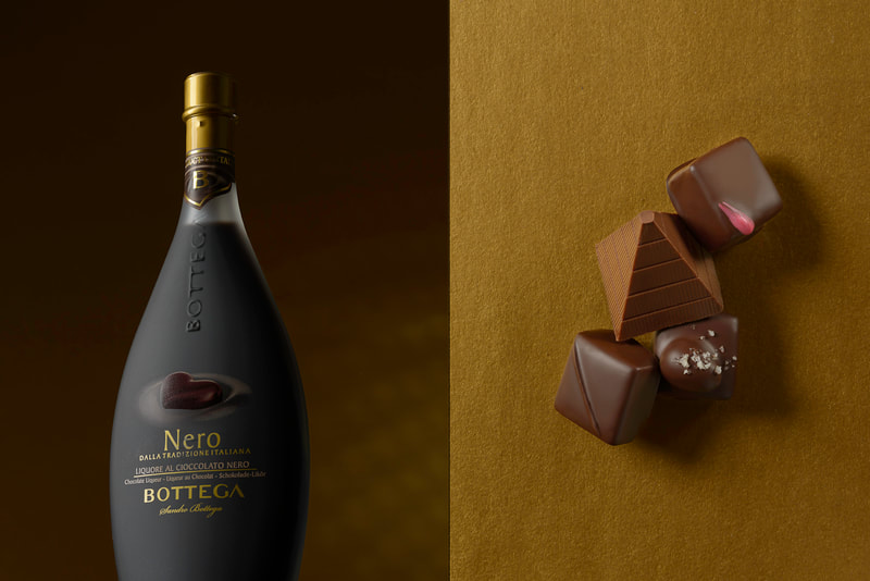A pair of images that show a curvaceous bottle of chocolate liquor on the left and a neatly arranged group of chocolates on gold paper on the right.