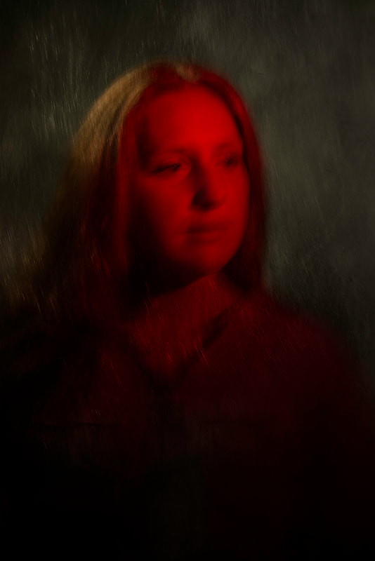 A dark reddish portrait of a young woman.