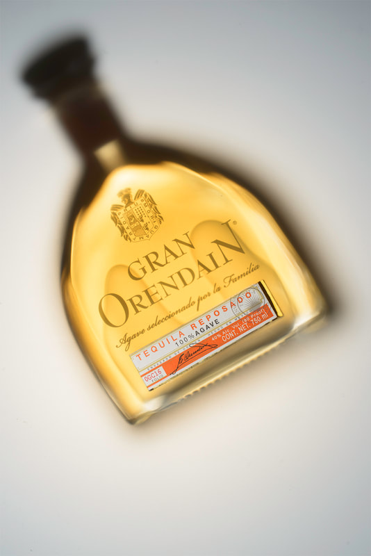 A top view of a bottle of Gran Orendain tequila on a white surface.