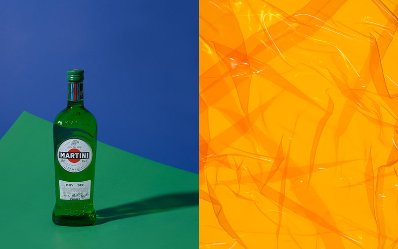 A pair of images with the left showing a single bottle of Martini Vermouth sitting on a green surface. The image on the right is a orange toned mass of wrinkles backlit so as to glow somewhat.
