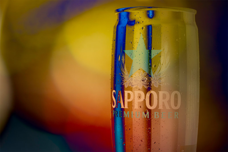 A can of Sapporo beer appears with inverted colours inspired by party scenes in movies.