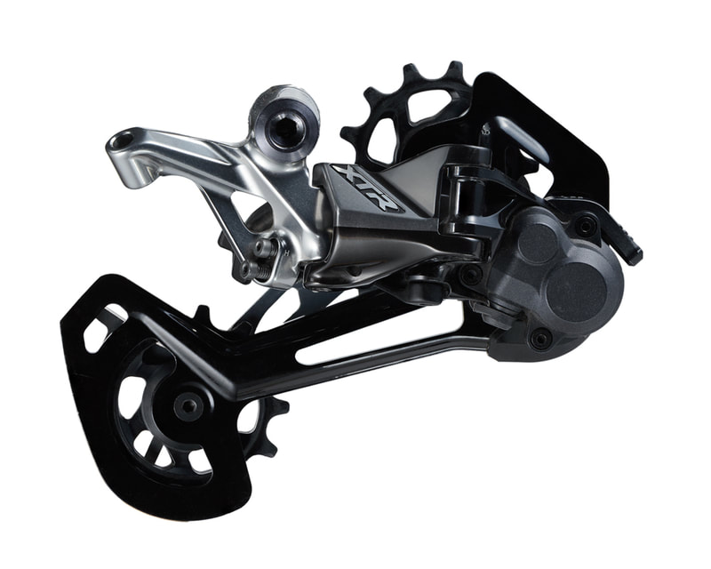 A photo of a Shimano XTR rear derailleur against a stark white background. Shot by photographer Mike Taylor in his Peterborough Ontario studio.
