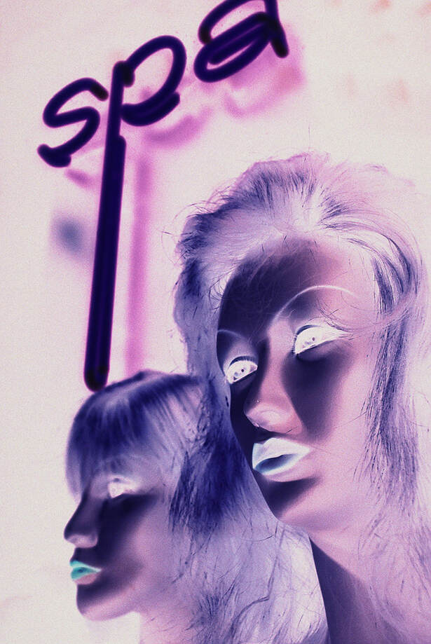 a colourful image of two mannequin heads in purple